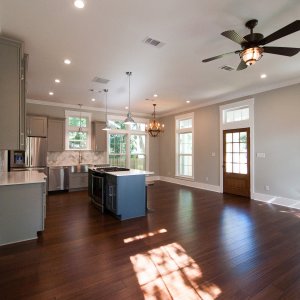 Bright and airy open living area in shotgun cottage by Good Foundations, Inc.