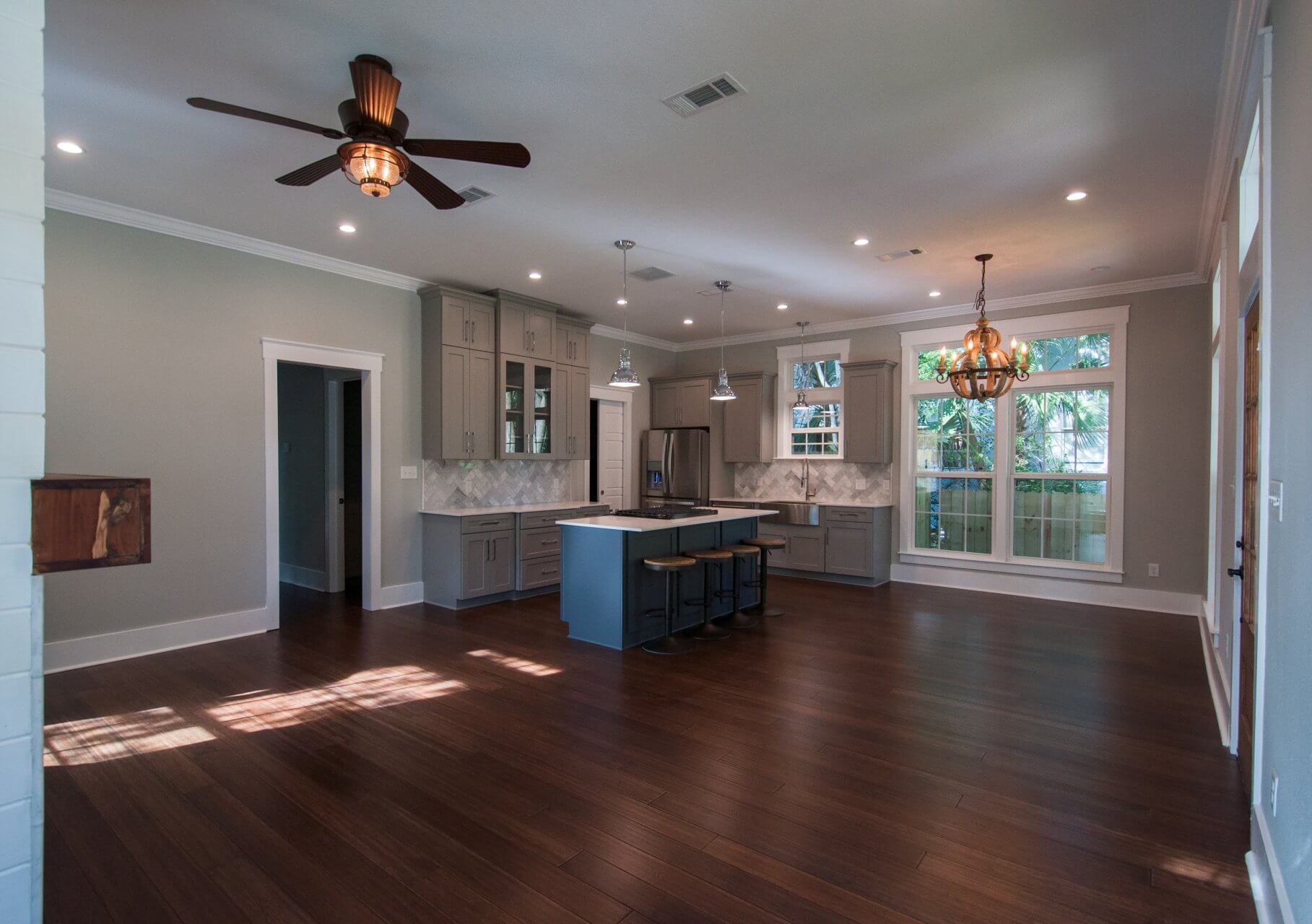 Open kitchen with bar stools in Shotgun Cottage on Lloyd Street in East Hill by Good Foundations, Inc.