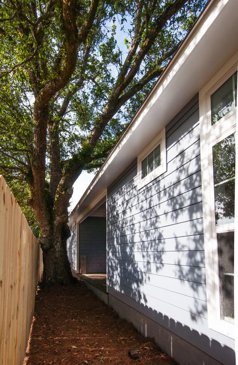 Porch and preserved legacy oak tree outside Shotgun Cottage on Lloyd Street in East Hill by Good Foundations, Inc.