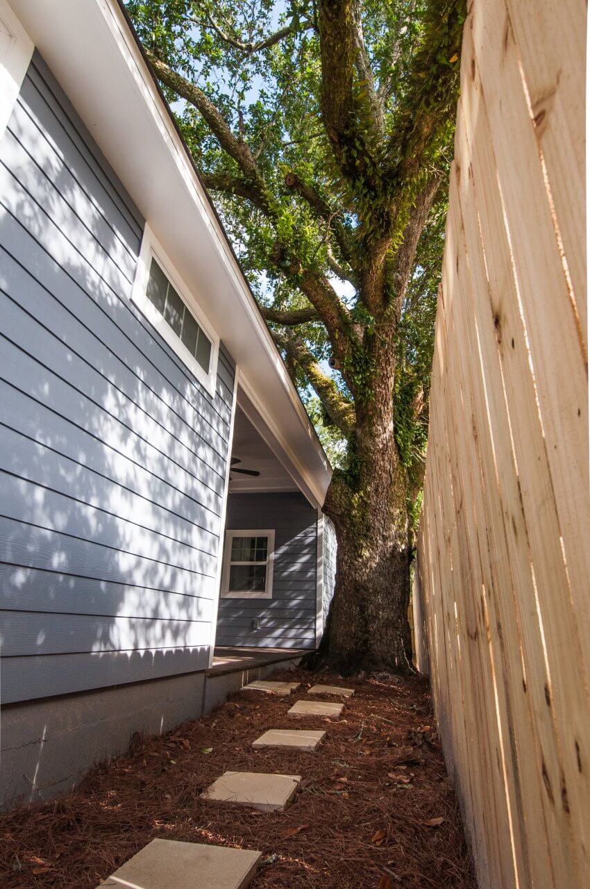 Stepping stones lead to porch by legacy oak tree outside Shotgun Cottage on Lloyd Street in East Hill by Good Foundations, Inc.